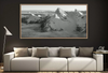 Framed black and white mountain landscape of Dent d'Oche above a modern sofa in a living room.