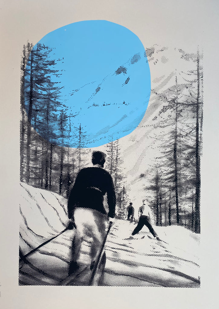 A limited edition screen print of a skier on a snowy mountain, predominantly in black, white, and gray tones with a blue circle emphasizing the sky.