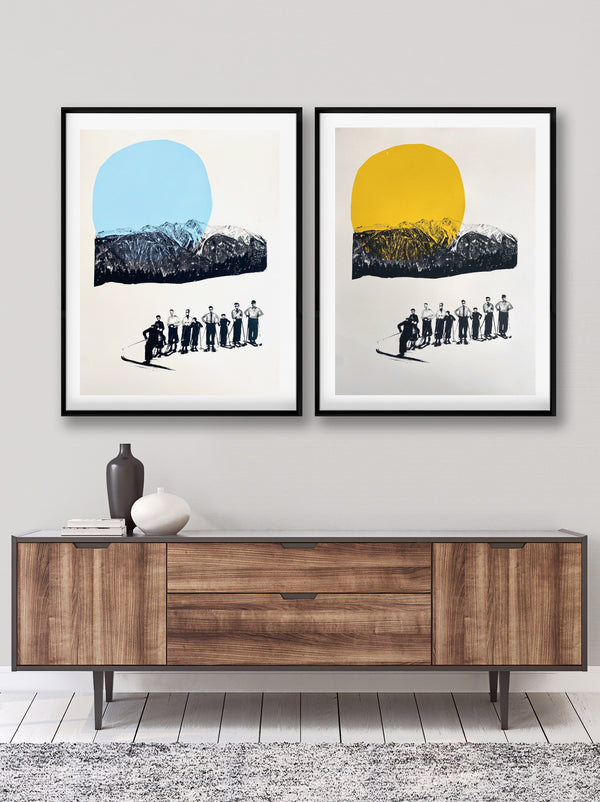 A room featuring 2 retro ski art prints framed featuring a yellow version and a blue version with mountains in the background, depicting a vintage ski scene with skiers in black and white attire.