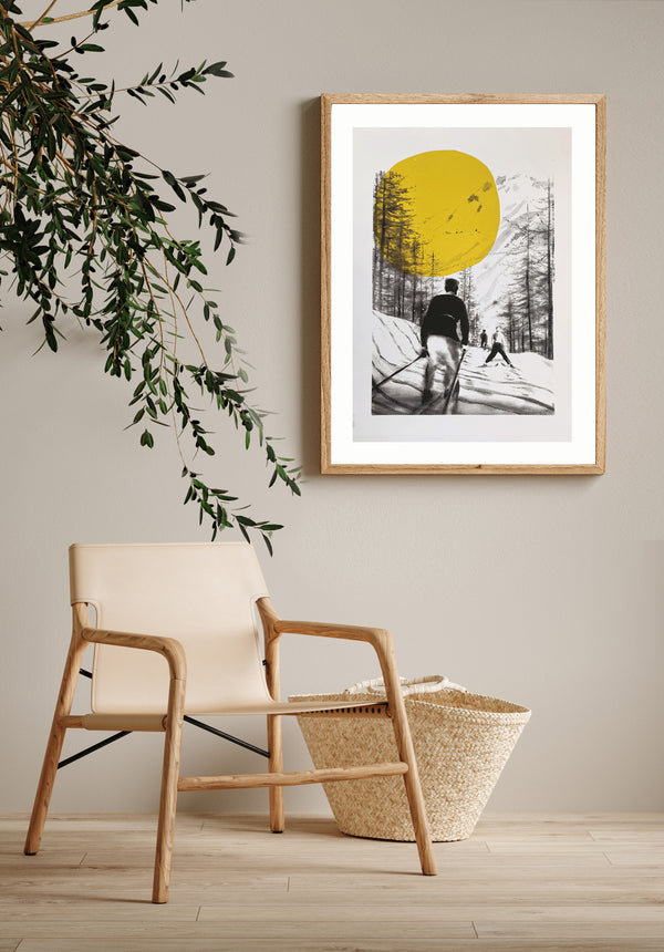 Ski de Printemps jaune, a Retro Ski Print framed on a wall witha. chair and a plant. Print features skiers and a big yellow sun