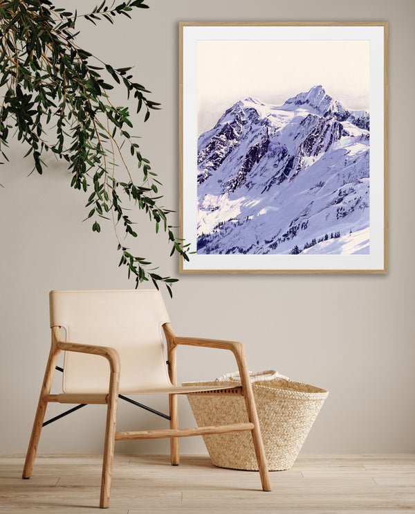 A realistic pen, paint marker, paint, and pastel artwork depiction of a snow-covered mountain range in blue, on a wall beside a chair and plant.