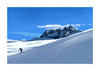 A stylized landscape art print depicting a snowy mountain range under a bright blue sky, with a small skier visible on the snow slope and Dents du Midi in the background.