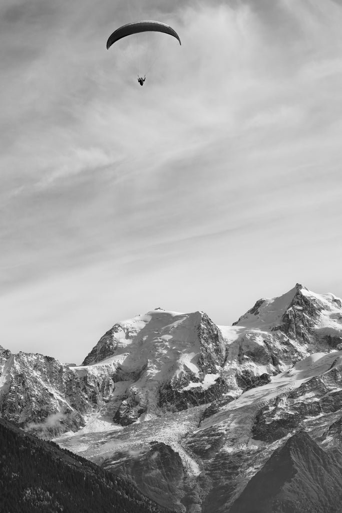 Mountain landscape art print photo of Paraglider flying over snow-capped mountains in black and white