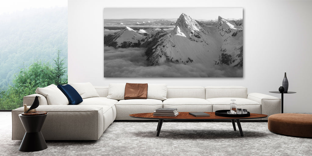 large print of Dent D'Oche above a sofa in a white room