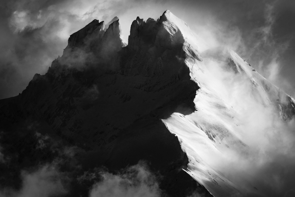 dramatic example of Dents Du Midi photography featuring the mountain coming out of the mist.