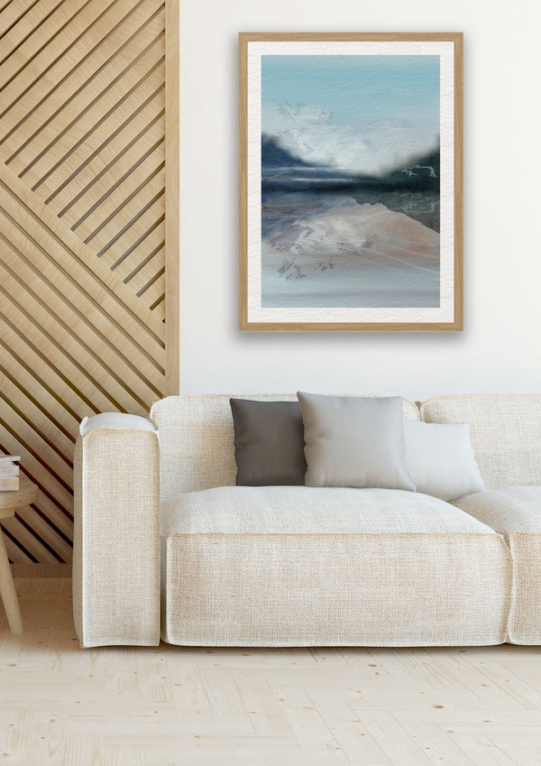 neutral mountain art print framed on a wall with a cream sofa in a modern chalet.