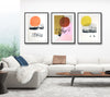 white living room featuring a wall with 3 vintage ski poster style screen prints framed.