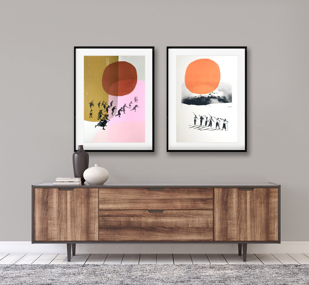 vintage ski poster style screen prints framed on a wall above a table