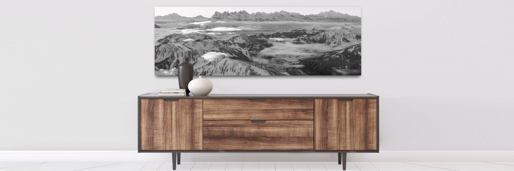 large photography  prints showing vhatel panorama and dents du midi on a wall over a console table
