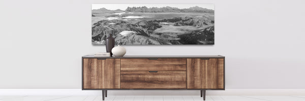 large photography  prints showing vhatel panorama and dents du midi on a wall over a console table