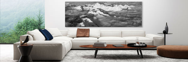 panoramic mountain landscape in black and white framed on a wall in a white living room 